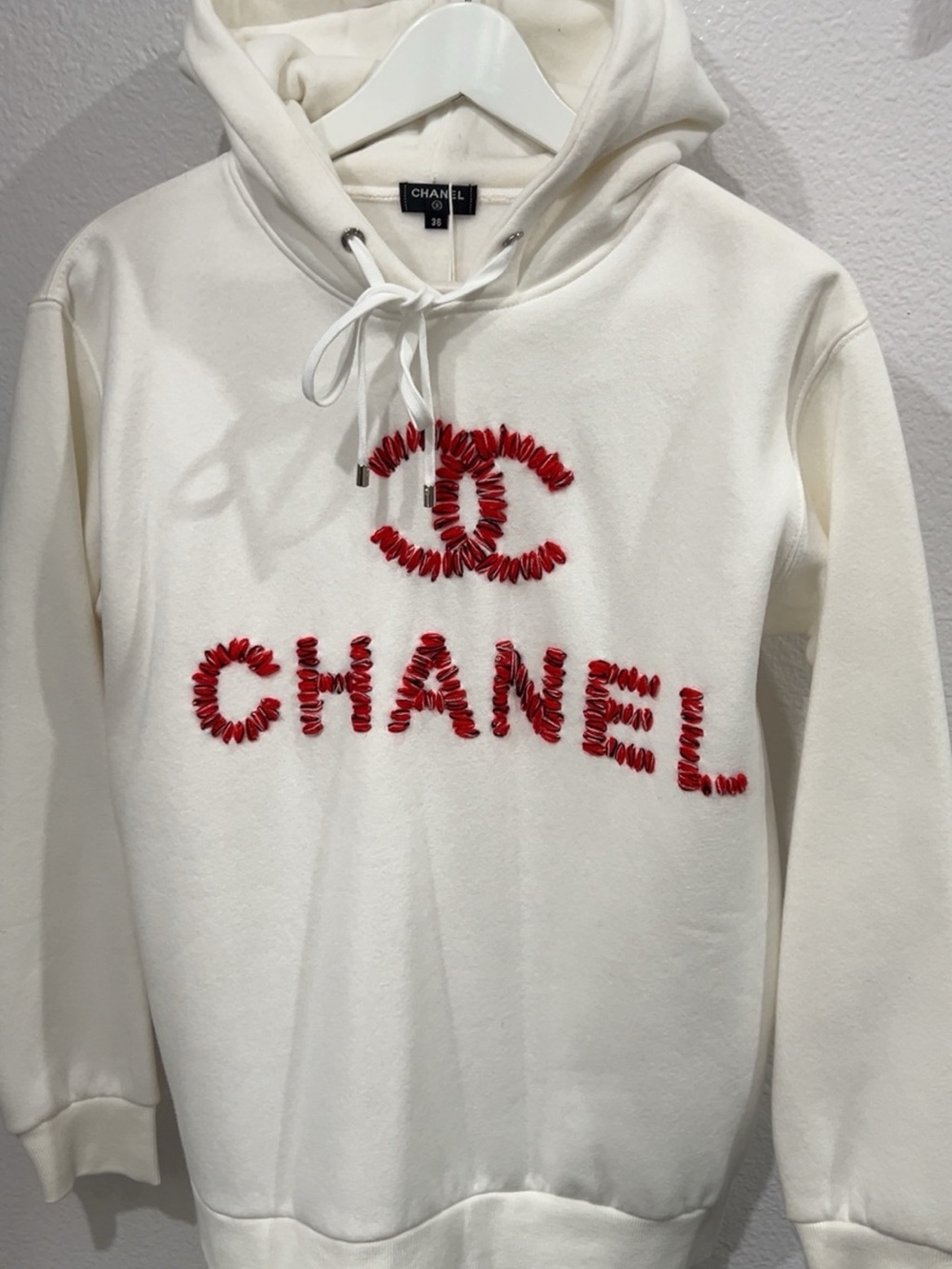 CHANEL Cream Hoodie Sweater with Red Stitched Embellished Logo